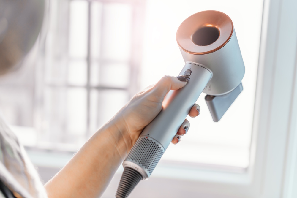 Girl hairdresser holding fan in hand. Closeup